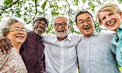 Diverse group of seniors outside smiling