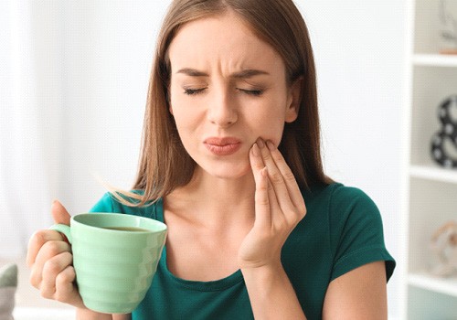 a woman experiencing tooth pain