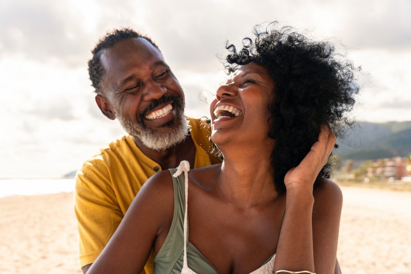 Older couple smiling and laughing outdoors